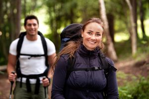 A pretty female on a camping trip with a male in the background
